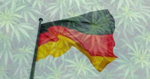 Waving German flag superimposed over a background of green cannabis leaves, symbolizing Germany's focus on medical cannabis policies and industry growth