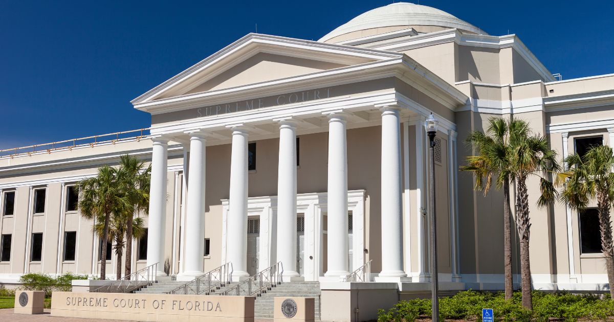 Supreme Court of Florida building with neoclassical columns, dome, and palm trees under a clear blue sky, symbolizing the Smart & Safe Florida lawsuit over the stalled recreational marijuana initiative