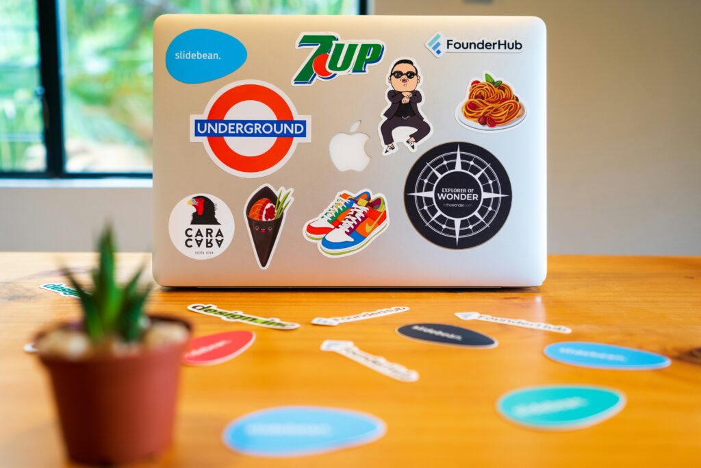 A laptop with brands on the cover.