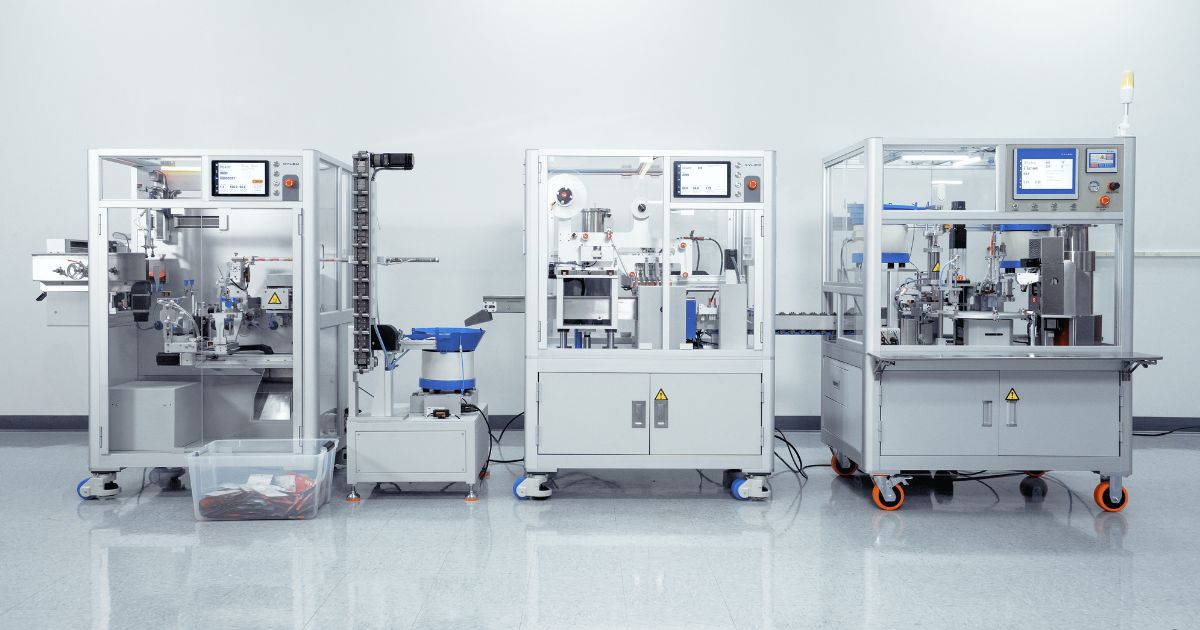 Three modular industrial machines with transparent panels and touchscreen interfaces, set in a clean, white production facility, showcasing advanced automation for vape cart manufacturing with precision and quality control