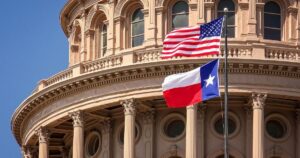 Upward view of the Texas State Capitol with the US and Texas flags waving in the foreground against a bright blue sky, symbolizing the legislative impact on the Texas hemp industry.