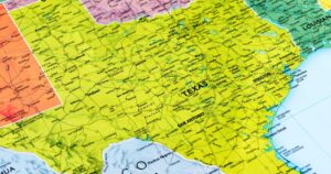 Detailed map of Texas and surrounding areas, highlighting major cities like Austin, Houston, and Dallas, along with highways, rivers, and national parks. The map uses green and yellow tones for land and blue for water, with clear labels for state borders and geographic features. Keywords: Texas smokable hemp ban