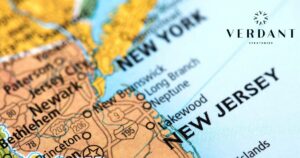 Close-up angled map of New York and New Jersey, highlighting cities like Newark, Jersey City, and Paterson, along with major roads. The 'VERDANT STRATEGIES' logo, featuring a circular chevron design, is prominently overlaid in the top right corner. Keywords: Cannabis Businesses in New York and New Jersey