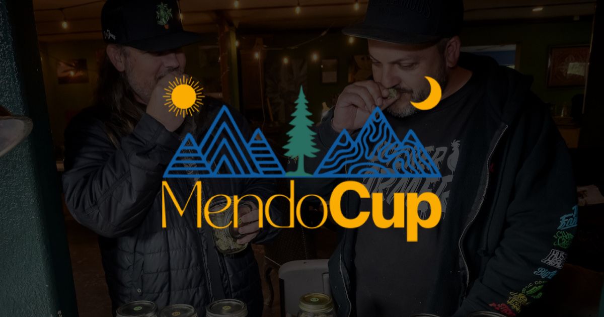 Promotional image for Mendo Cup 2026 featuring a central logo with stylized blue mountains, a yellow sun, a crescent moon, and a green pine tree. The background shows two men in a dimly lit room inspecting cannabis in glass jars, symbolizing Mendocino County's cannabis culture and competition