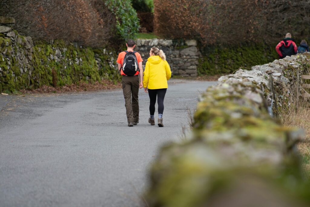 An image of 2 people on a walking trail.