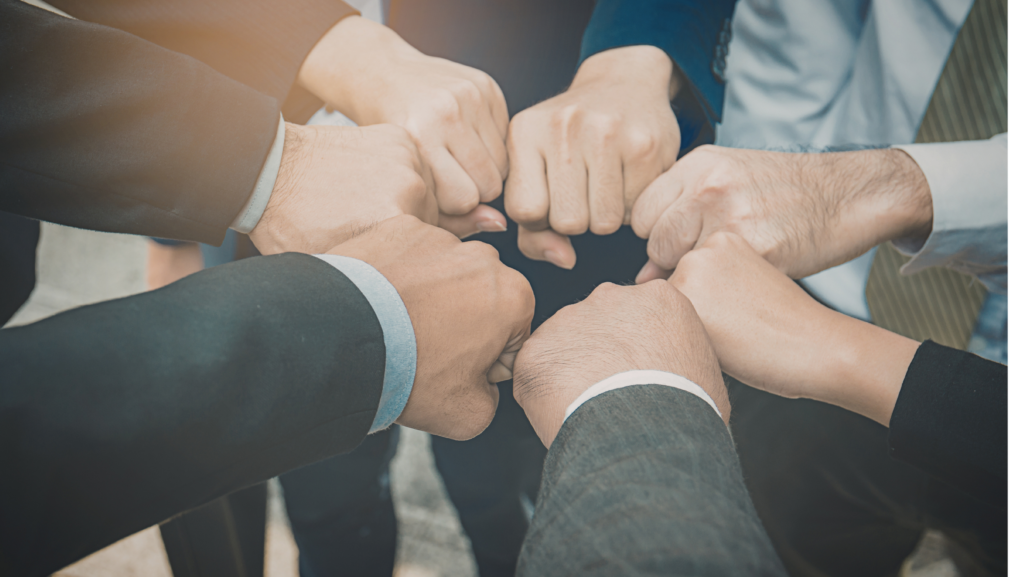 Men holding their fists together showing connection.