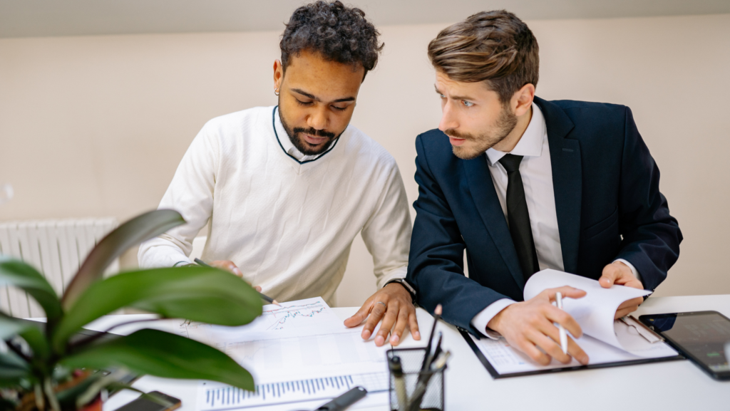 Two men sitting at their desk at work.